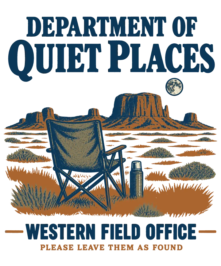 Print artwork: an empty folding camp chair and a thermos in tall clay-orange grass, facing flat-topped desert buttes under a small full moon, in navy, slate blue, clay and khaki. The navy title above reads Department of Quiet Places. Below it, between two clay rules, reads Western Field Office, and under that in clay, Please leave them as found.