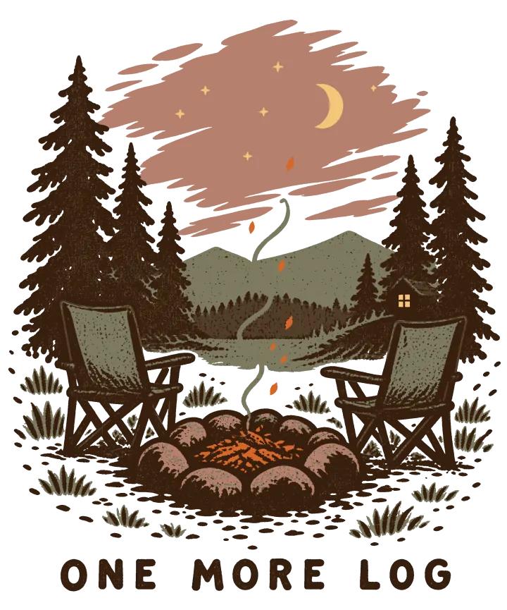 Print artwork: two empty folding camp chairs facing a stone fire ring where the fire has burned down to orange embers and a thin curl of smoke. Tall pines stand on both sides, and beyond them a lake, hills and a small cabin lie under a pink night sky with stars and a crescent moon. Below, in spaced brown capitals: One more log.