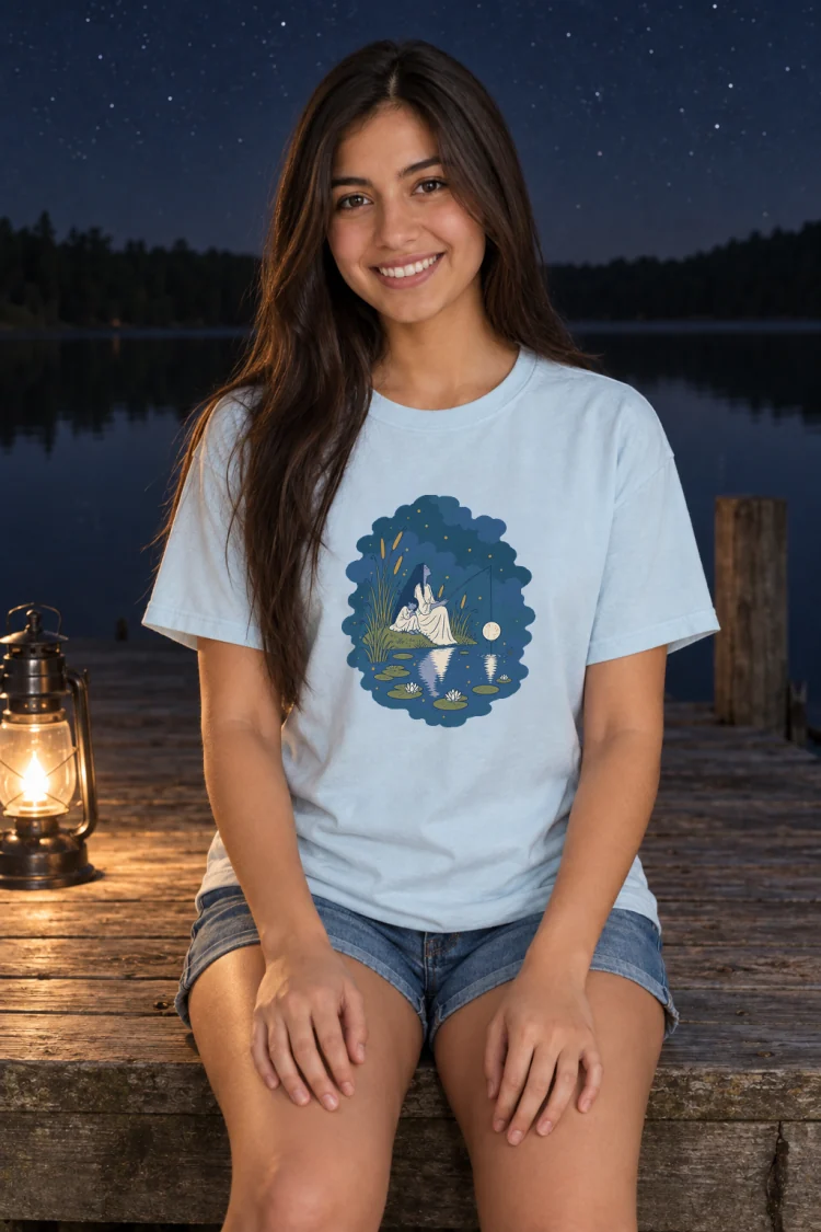 AI-generated image of a fictional model wearing the Fishing for the Moon Tee in Chambray, size S, at 5′4″ tall.