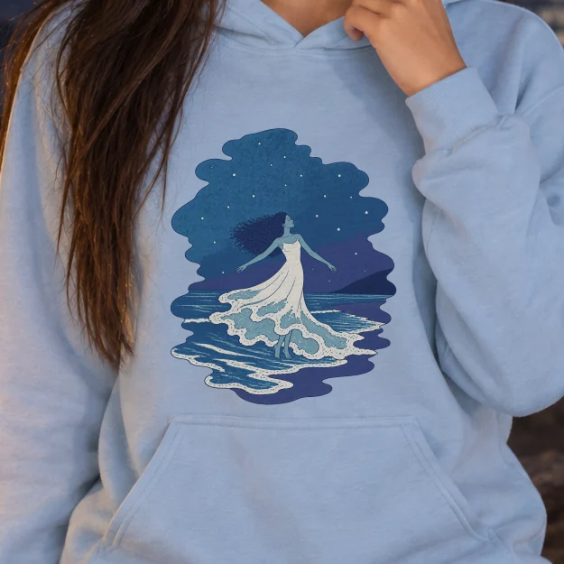 AI-generated image of a fictional model wearing the The Tide Dancer Hoodie in Light Blue, size S, at 5′4″ tall, cropped to the print.