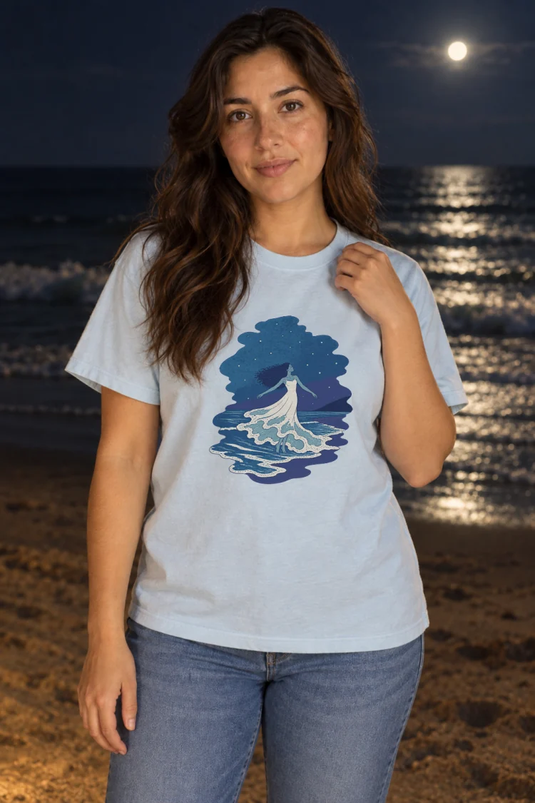 AI-generated image of a fictional model wearing the The Tide Dancer Tee in Chambray, size M, at 5′4″ tall.