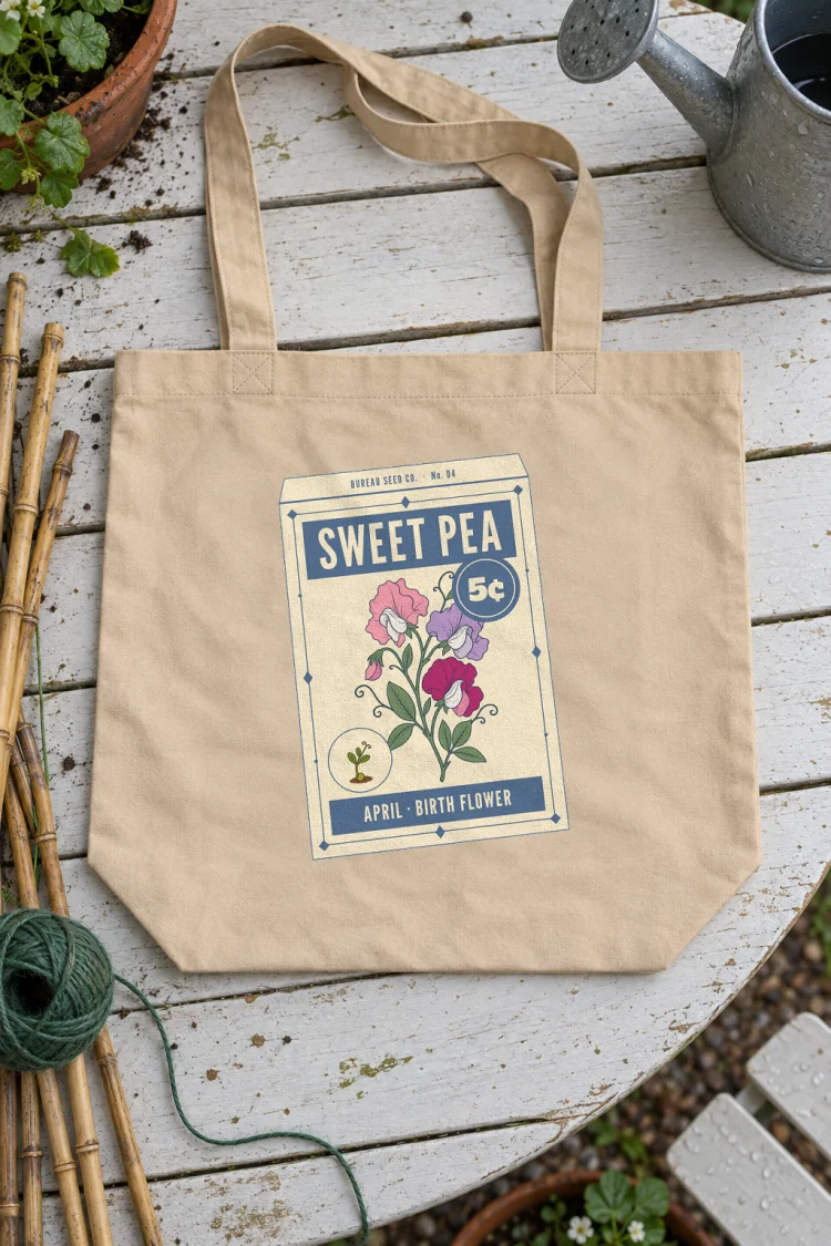 AI-generated image of the April Sweet Pea Birth Flower Tote in Oyster on a table with everyday things around it.