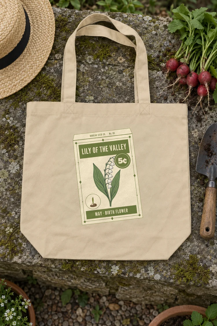 AI-generated image of the May Lily of the Valley Birth Flower Tote in Oyster on a table with everyday things around it.